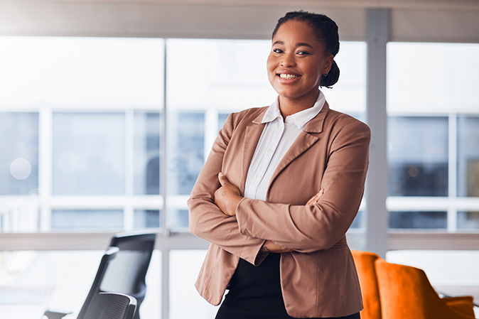 smiling woman in blazer crossing her arms